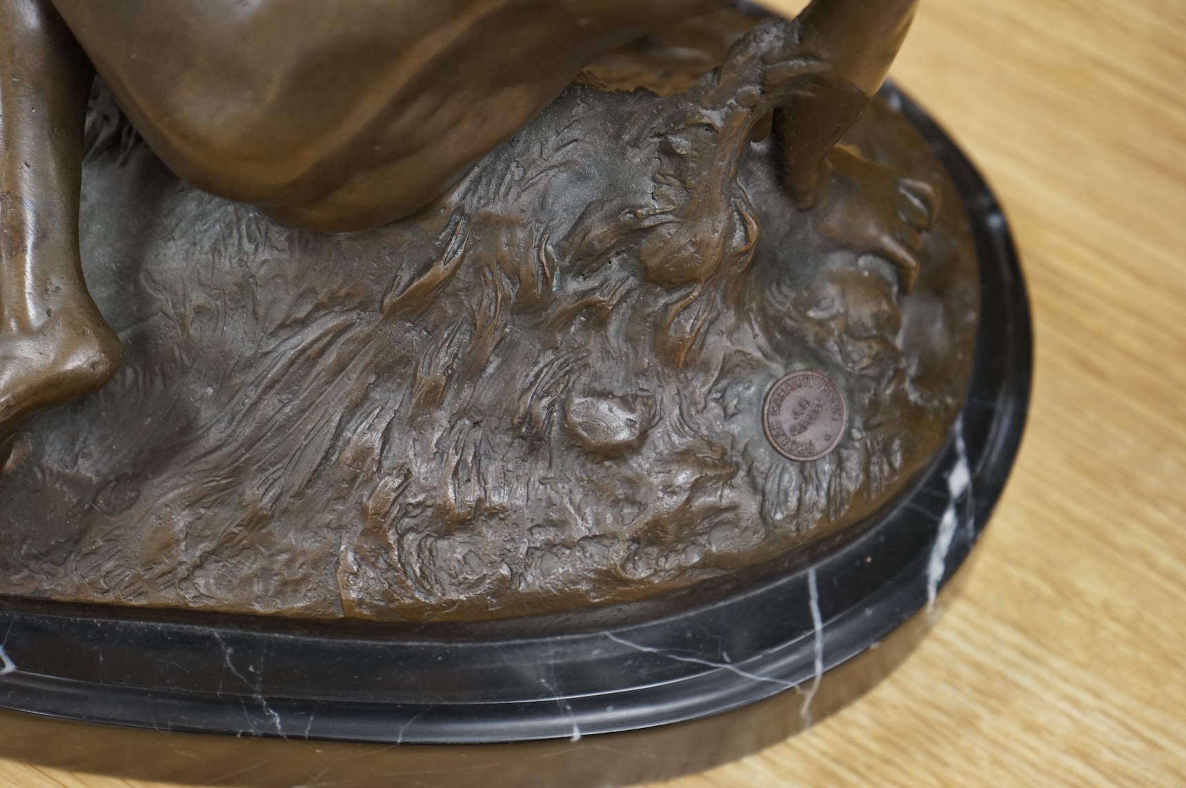 After Mme Leon Bertaux, bronze of a female reclining nude with butterfly, 28cm wide x 27cm high.
